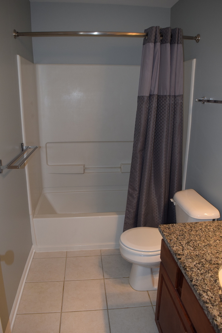 4110 Bethlehem Road Aurora, IL 60504 - Photo 46 of 53 a bathroom with a granite countertop bathtub shower and toilet