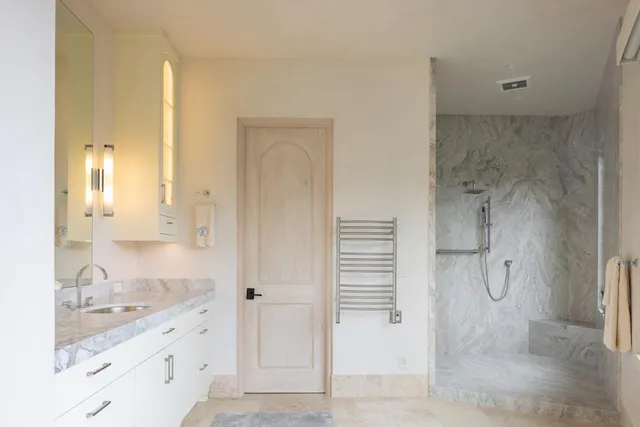 a balcony with wooden floor table and chairs