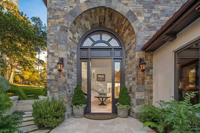 a living room with furniture fireplace and a floor to ceiling window