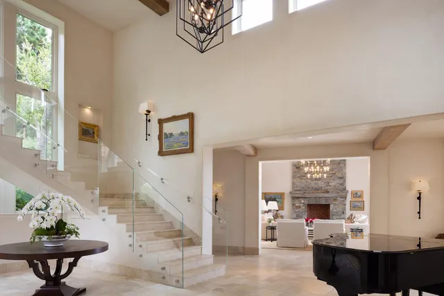 a living room with furniture a chandelier and a fireplace