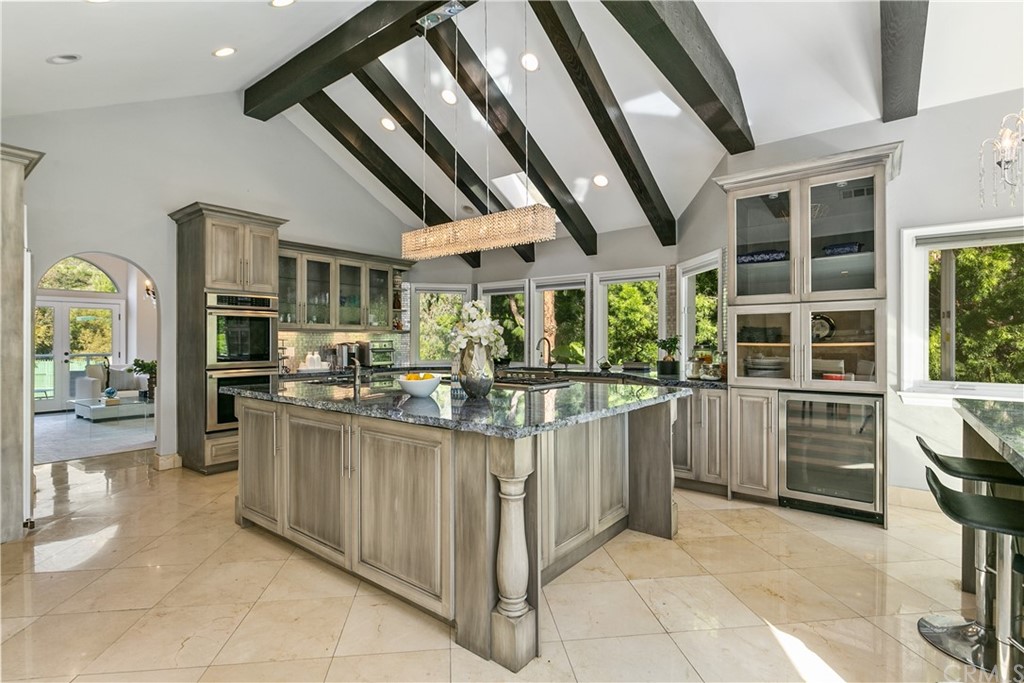 10282 Ambervale Lane North Tustin, CA 92705 - Photo 14 of 50 a kitchen with stainless steel appliances kitchen island granite countertop a refrigerator and a stove