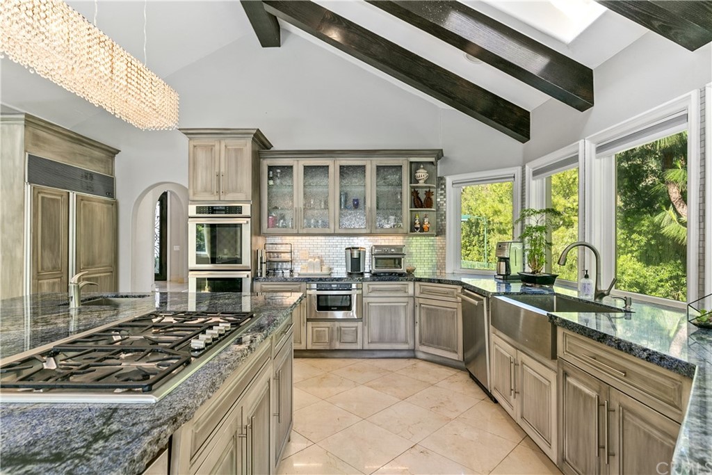 10282 Ambervale Lane North Tustin, CA 92705 - Photo 15 of 50 a kitchen with stainless steel appliances granite countertop a stove and a sink