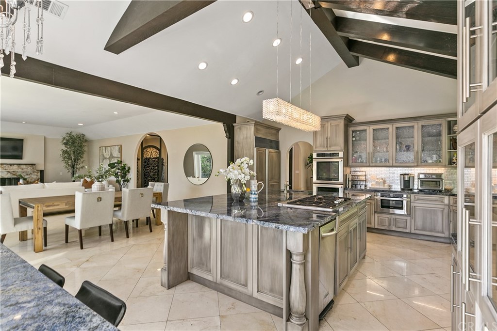 10282 Ambervale Lane North Tustin, CA 92705 - Photo 18 of 50 a kitchen with stainless steel appliances kitchen island granite countertop a stove and cabinets