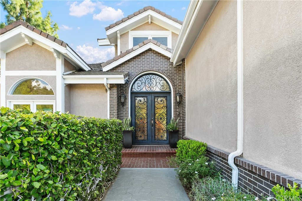 10282 Ambervale Lane North Tustin, CA 92705 - Photo 2 of 50 a view of a house with large windows and flower plants