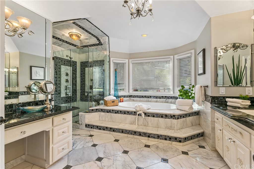 10282 Ambervale Lane North Tustin, CA 92705 - Photo 25 of 50 a spacious bathroom with a granite countertop tub and a large mirror