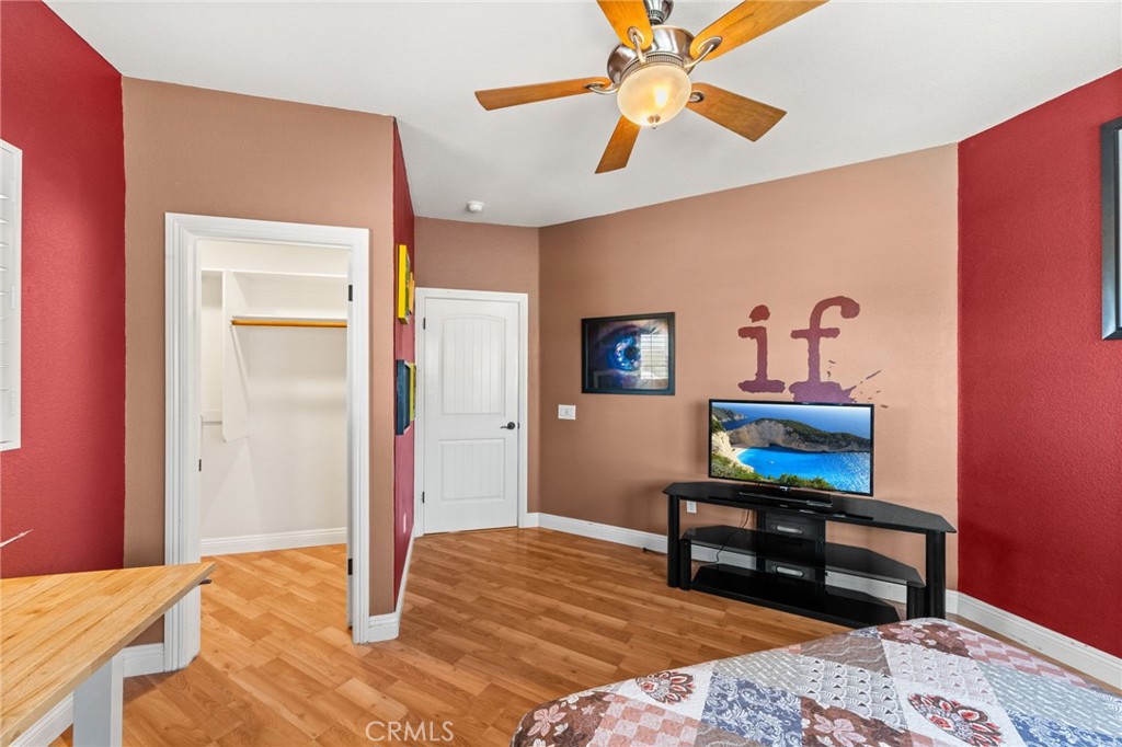 38136 Butterfly Court Yucaipa, CA 92399 - Photo 60 of 71 a bedroom with a bed a desk and chair