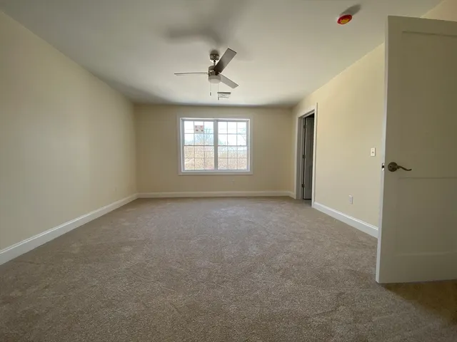 a view of a livingroom with a ceiling fan and window
