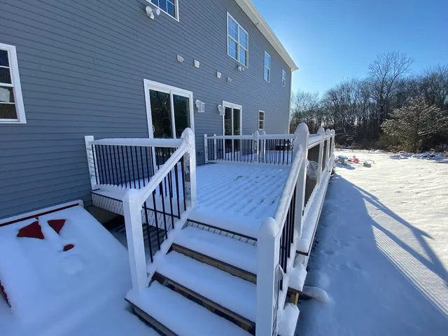 a view of a deck with chairs and wooden floor