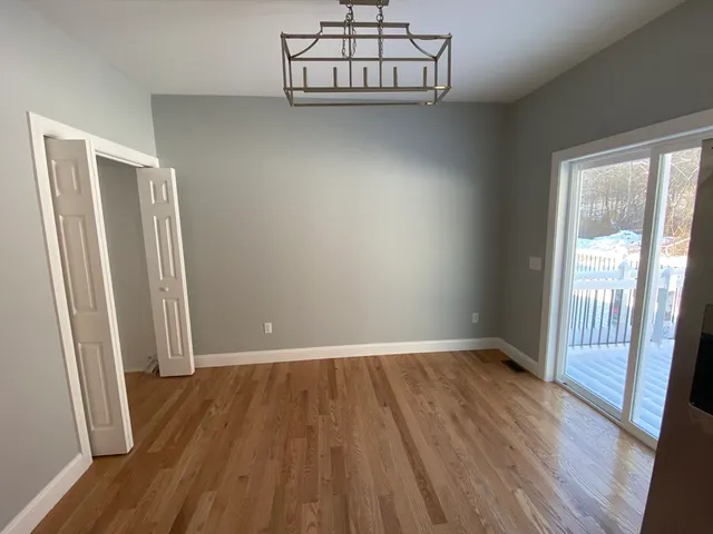 a kitchen with stainless steel appliances granite countertop a refrigerator a sink dishwasher a stove and a wooden floors