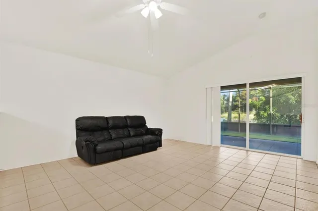 a living room with furniture and a black and white floor