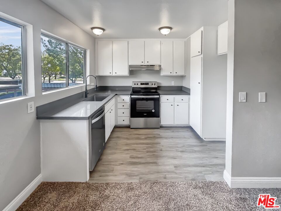 234 Springview Irvine, CA 92620 - Photo 11 of 19 a kitchen with stainless steel appliances granite countertop a stove a sink and a refrigerator