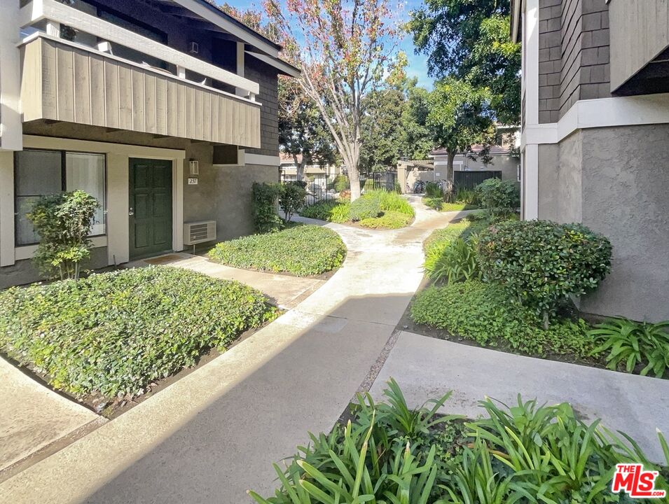 234 Springview Irvine, CA 92620 - Photo 6 of 19 a view of a house with a small yard plants and a fountain