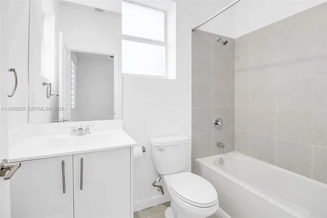 a bathroom with a sink toilet vanity and shower