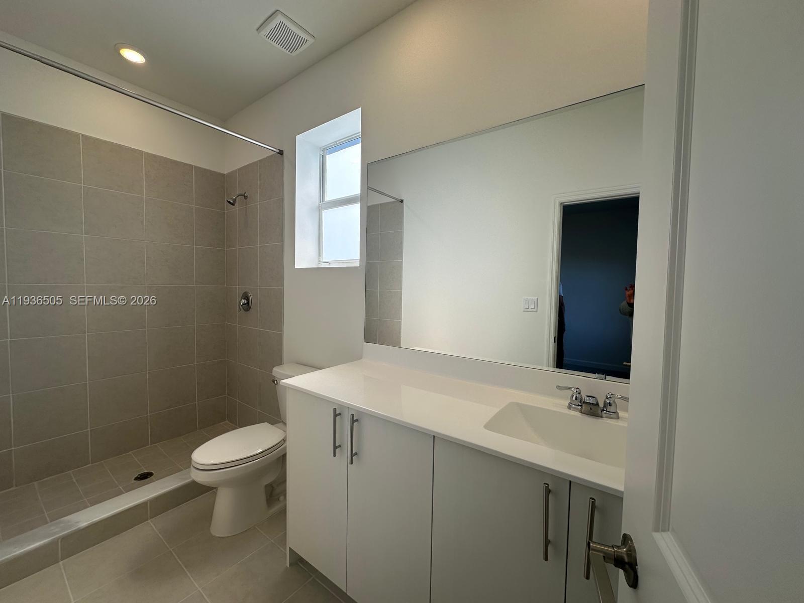 26848 Southwest 121st Avenue Homestead, FL 33032 - Photo 6 of 9 a bathroom with a sink a toilet and shower