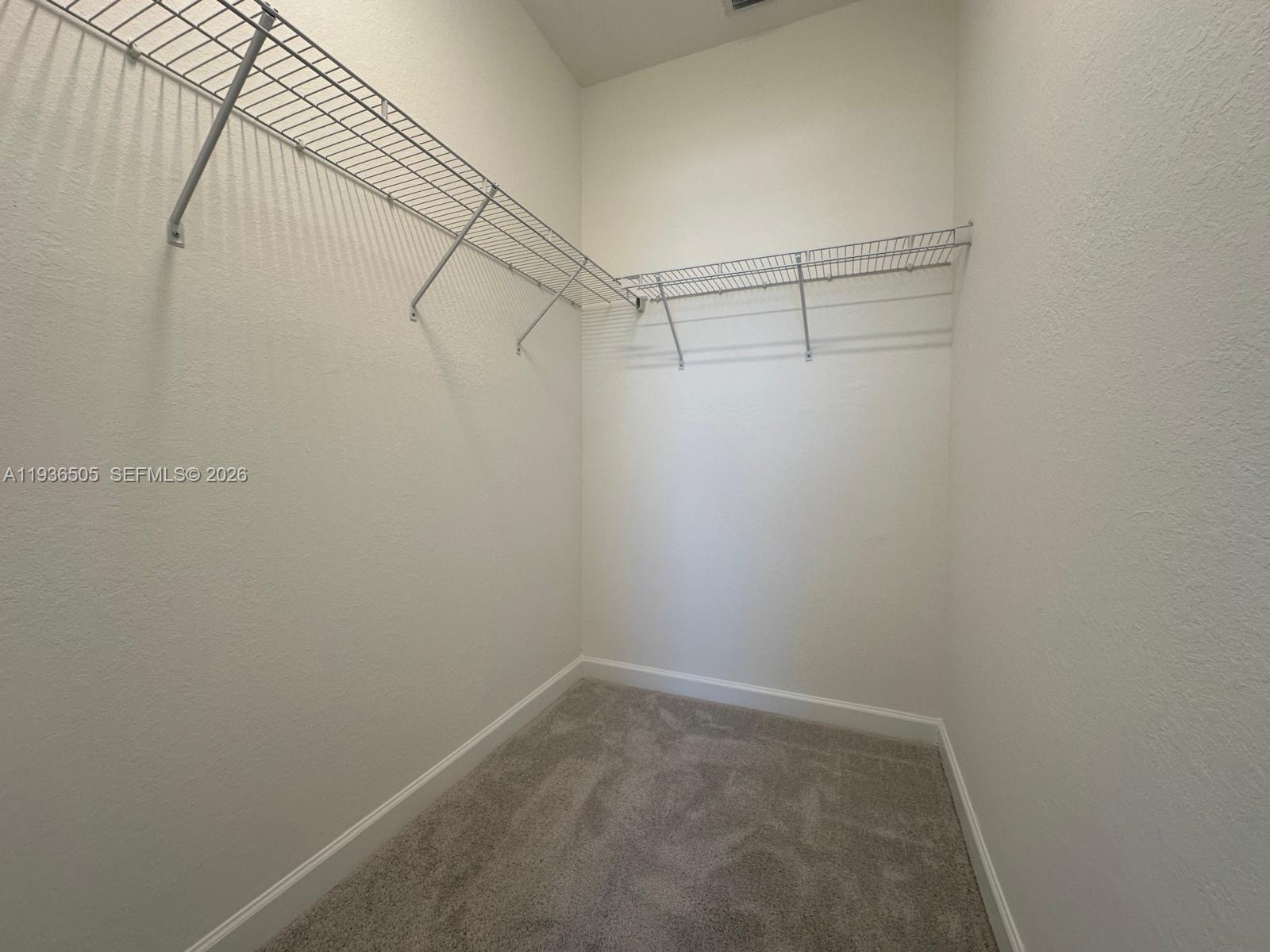 26848 Southwest 121st Avenue Homestead, FL 33032 - Photo 7 of 9 a view of a room with racks on the wall