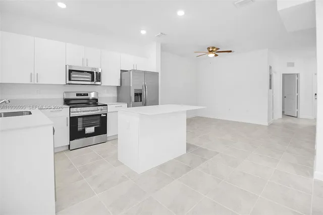 a kitchen with cabinets and stainless steel appliances