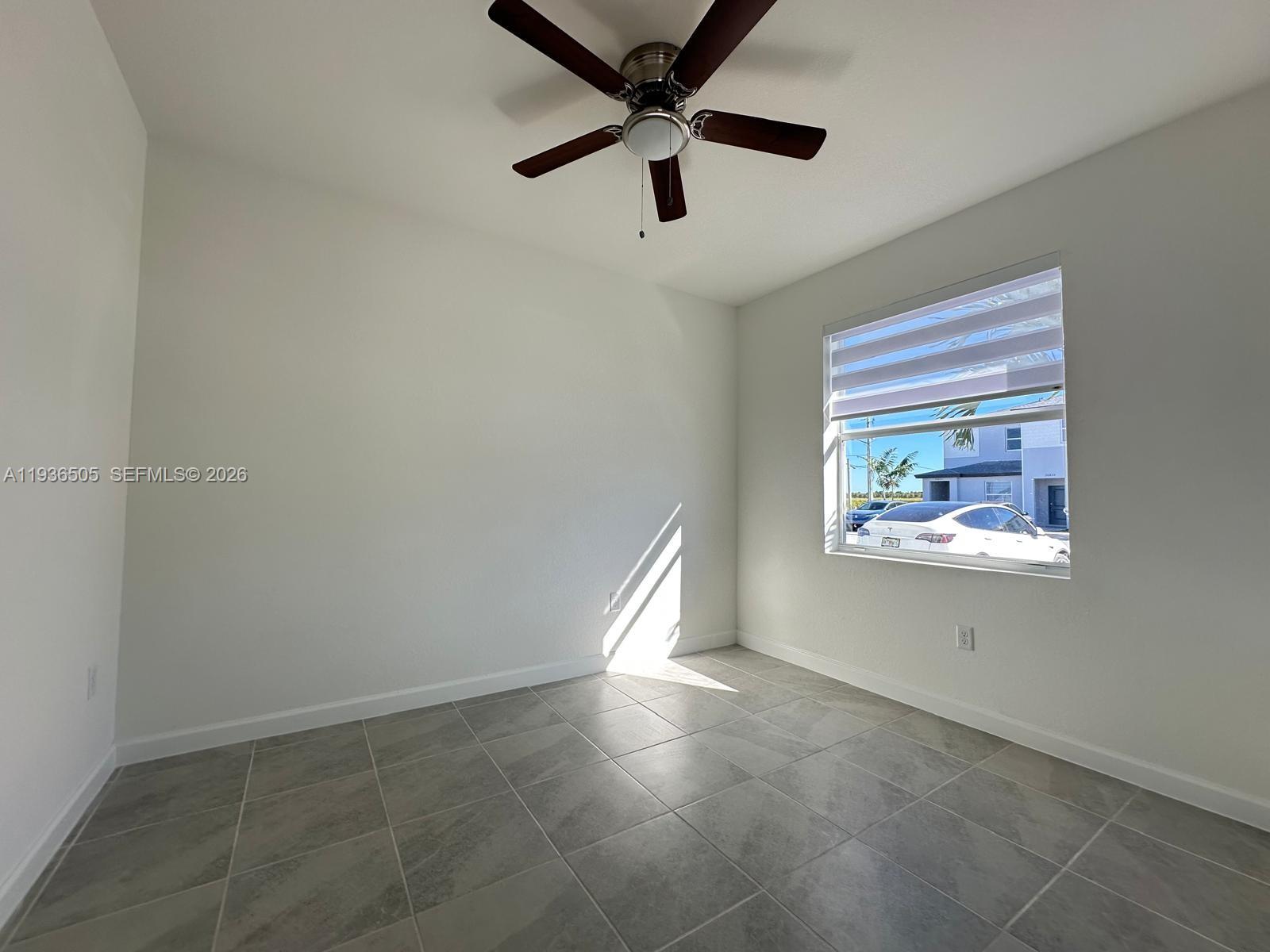 26848 Southwest 121st Avenue Homestead, FL 33032 - Photo 8 of 9 a view of an empty room and window