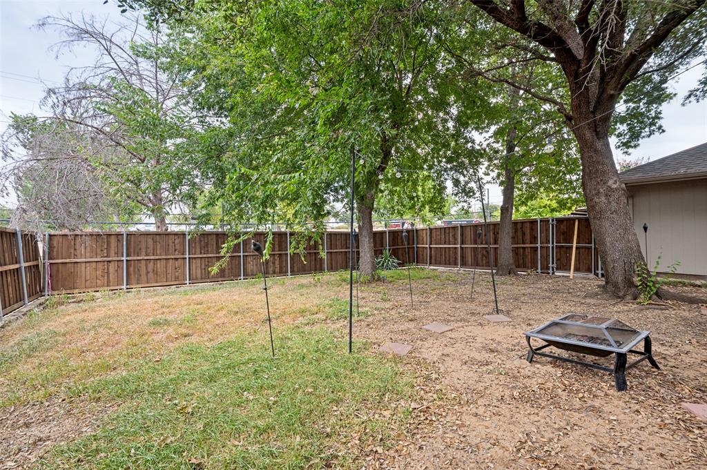 1006 Ridgeview Carrollton, TX 75007 - Photo 24 of 27 Spacious outdoor area featuring a wood fence and mature trees