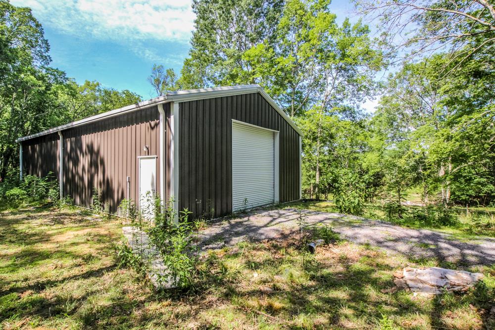 185 Osborne Road Watertown, TN 37184 - Photo 3 of 19 a backyard of a house with lots of green space and wooden fence