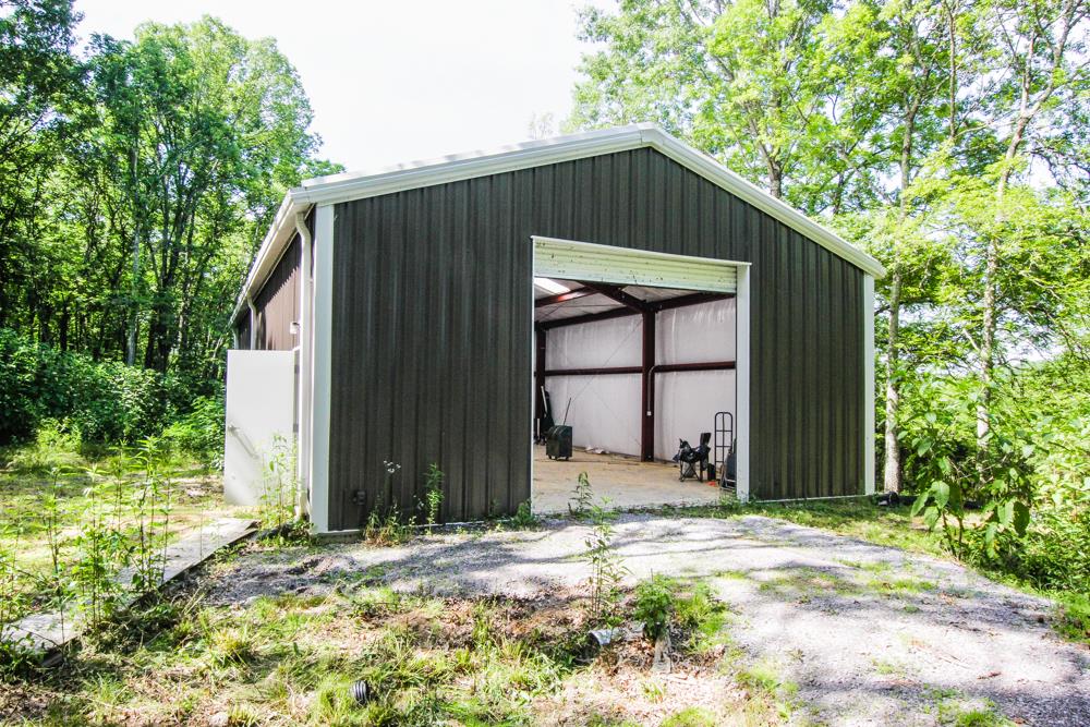 185 Osborne Road Watertown, TN 37184 - Photo 4 of 19 a backyard of a house with large trees and wooden fence