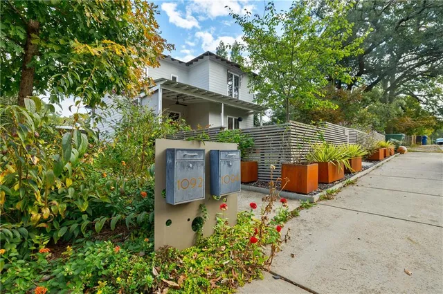 an aerial view of a house with large trees