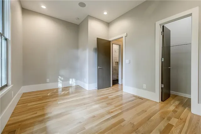a view of empty room with wooden floor