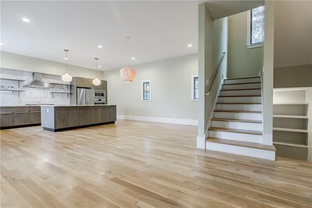a view of kitchen and hall with wooden floor