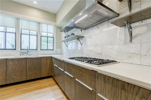 a kitchen with granite countertop a stove and a sink