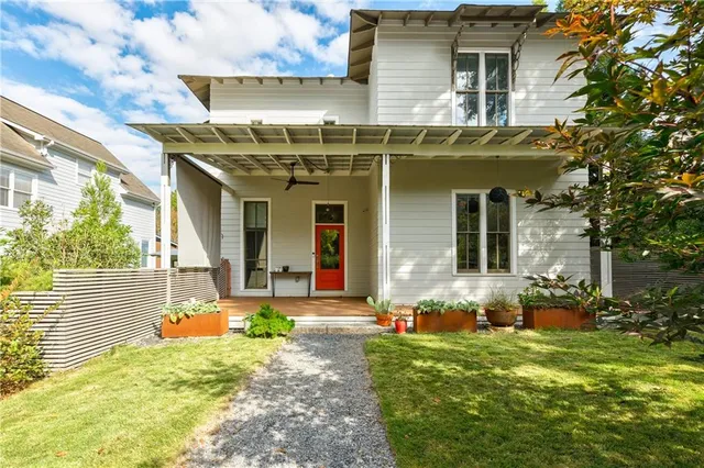 a view of a house with yard and sitting area