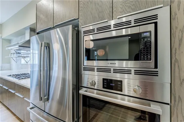 a kitchen with granite countertop stainless steel appliances and counter space