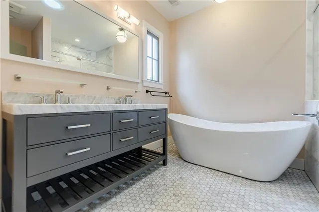 a bathroom with a sink a toilet and a mirror