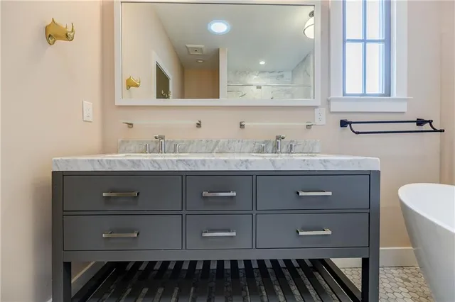 a view of bathtub in middle of bathroom