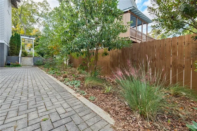 a backyard of a house with lots of green space and fountain