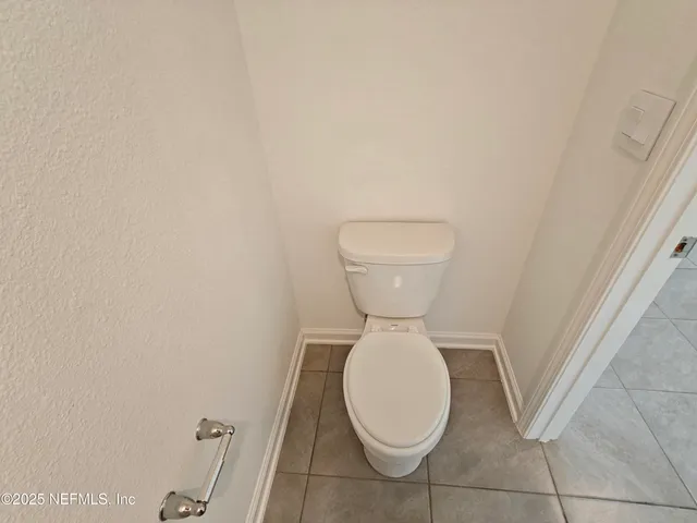 a white toilet sitting next to a bath tub and a shower