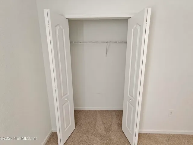 a view of an empty room with white walls