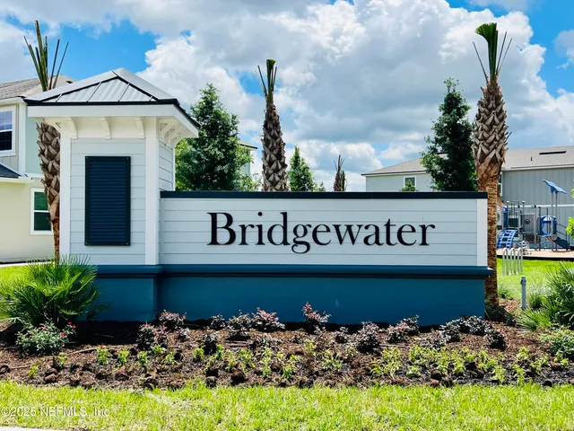 a sign that is in front of flowers