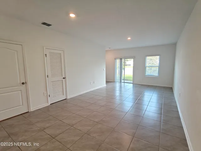 a kitchen with white cabinets stainless steel appliances and a sink
