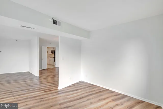 a view of a room with wooden floor and bathroom