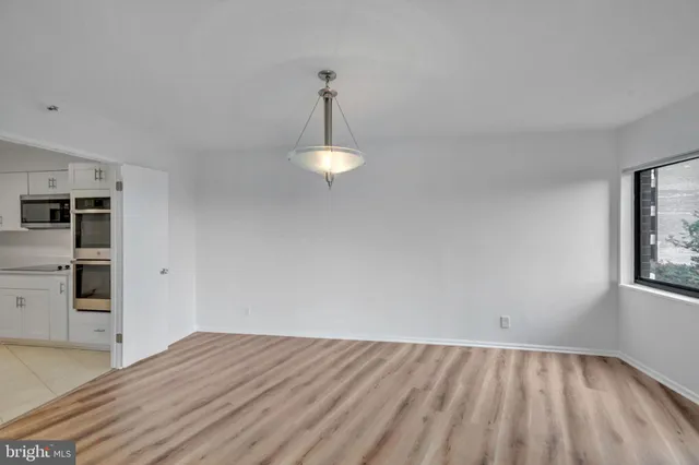 a kitchen with stainless steel appliances a sink a refrigerator and cabinets