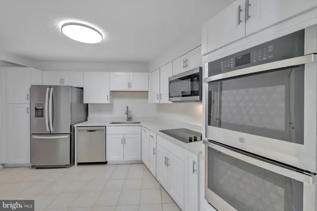 a bathroom with a sink mirror and a shower