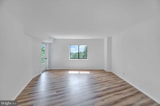 a view of an empty room and wooden floor