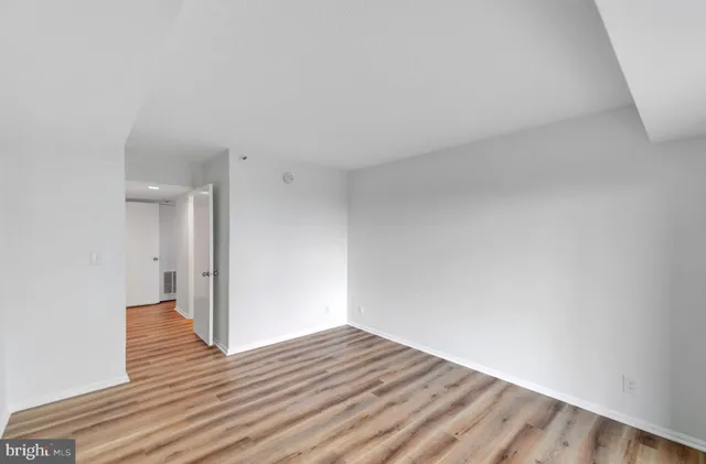 a spacious bathroom with a double vanity sink a mirror and a shower