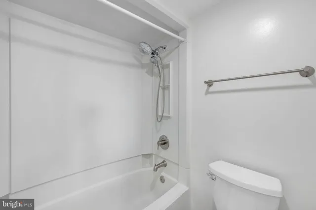 a view of a hallway with wooden floor and closet