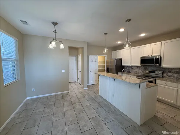 a large kitchen with cabinets