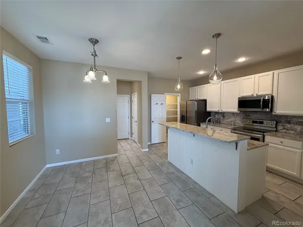 a large kitchen with cabinets
