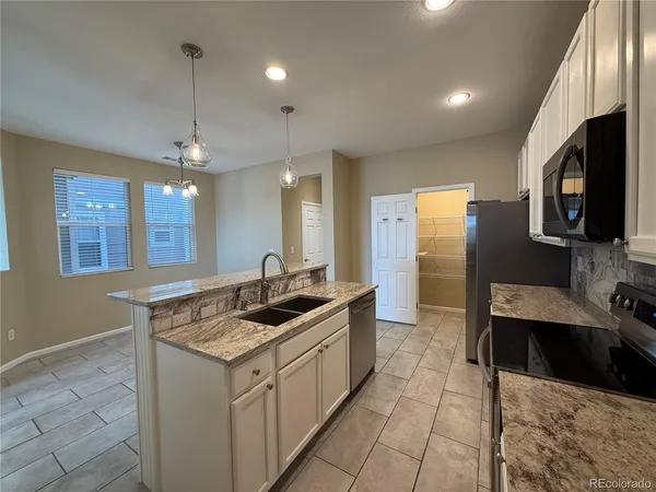 a kitchen with a sink stove and refrigerator