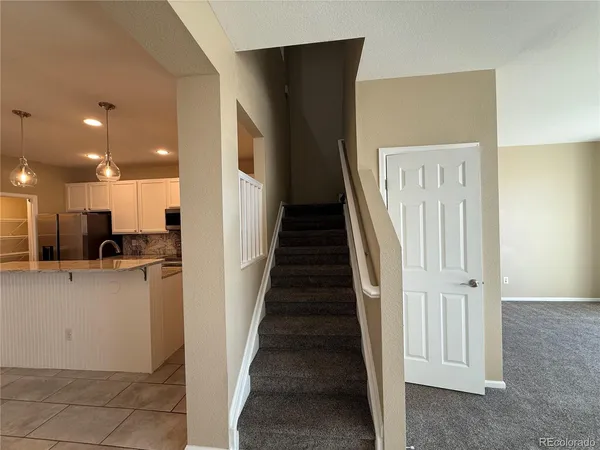 a view of a kitchen with a refrigerator a sink and dishwasher