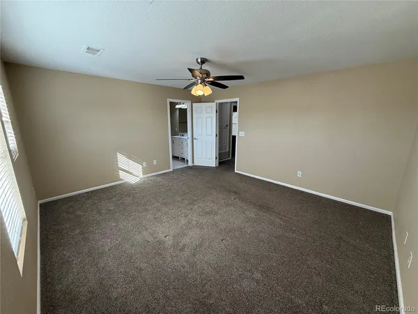 a view of a livingroom with a ceiling fan and window