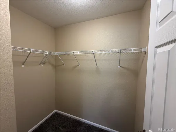 a view of an empty room with a ceiling fan