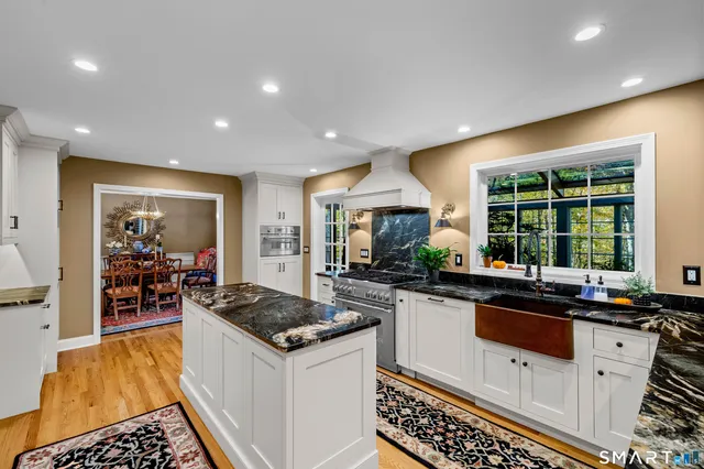 a kitchen with counter top space appliances and windows